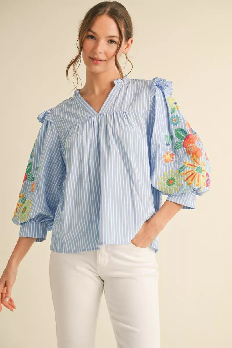 Beautiful Top with 3/4 puff sleeves and embroidered accents.