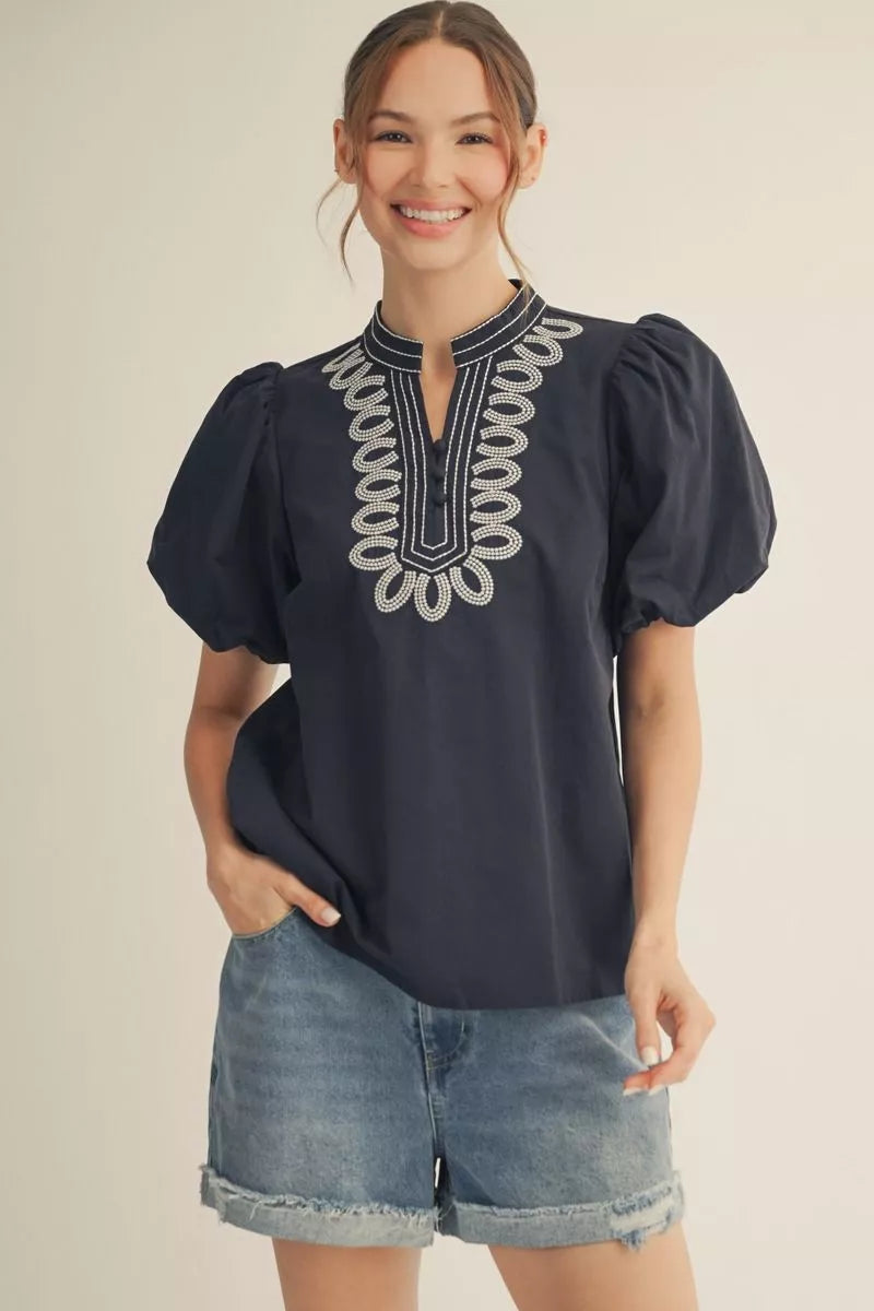 Navy short sleeve top with embroidery detail.