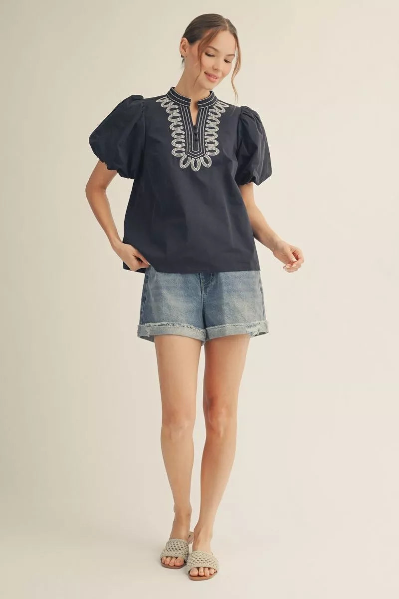Navy short sleeve top with embroidery detail.