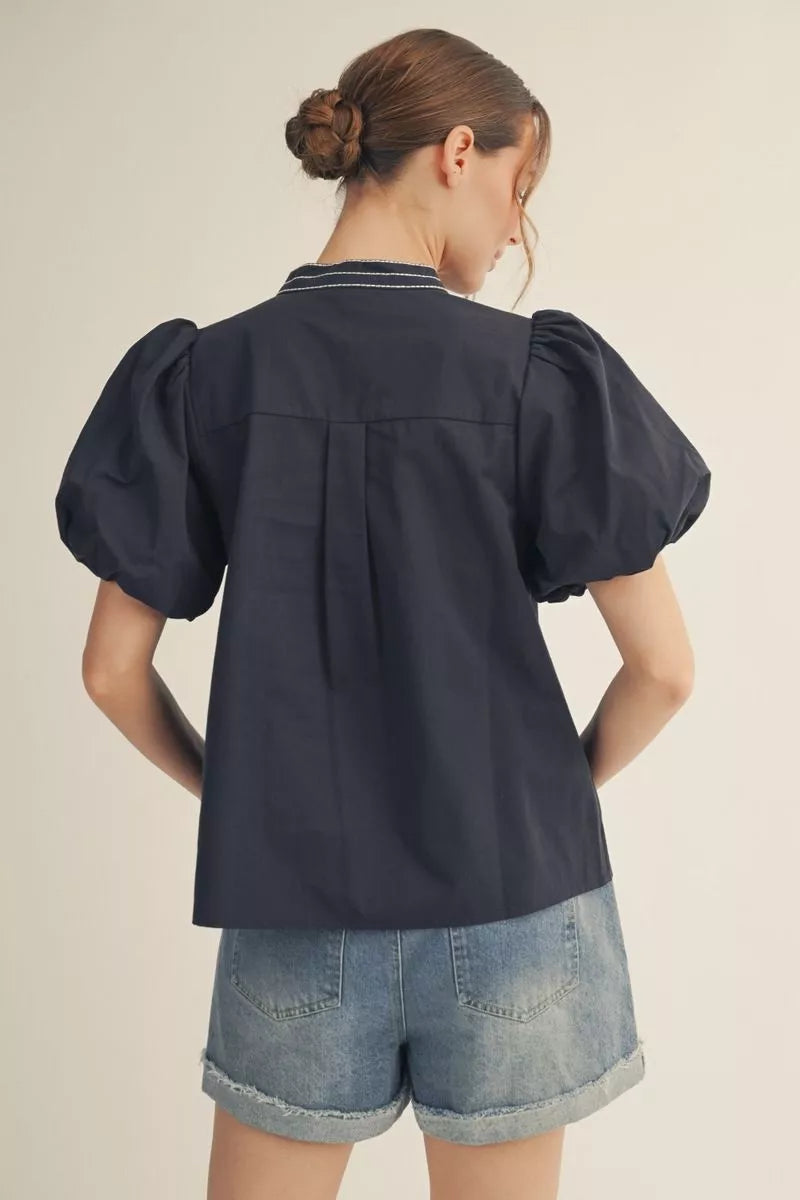 Navy short sleeve top with embroidery detail.